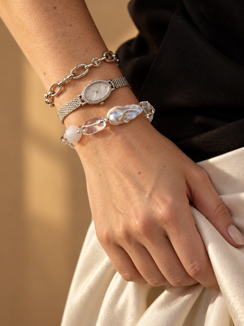 Contrast bead bracelet worn with a watch in golden sunlight